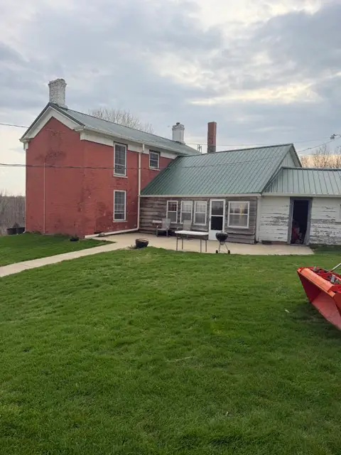 Completed metal roofing around a chimney from the Big Dog Roofing project gallery